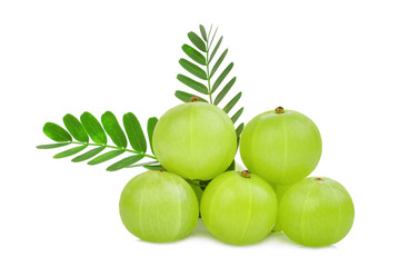 pile of indian gooseberry fruit with green leaves isolated on white background