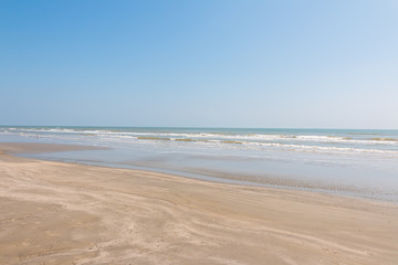 Fototapeta na wymiar Clean sandy beach with blue ocean and clear sky. Galveston Island, Texas, Houston.