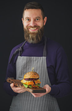 Smiling Man holding tray with chicken burger.