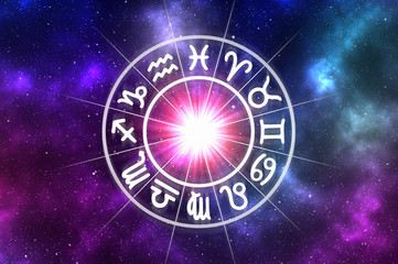 Zodiac signs inside of horoscope circle on universe background