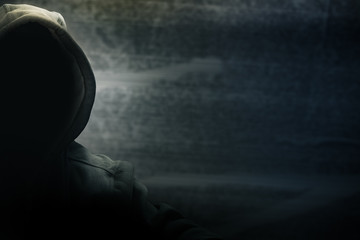 Hacker half face and black head and grunge background, terrorism and internet criminal cyber concept