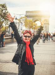 Happy attractive mature woman retired on the Champs Elysees in Paris. Travel, outdoor activities,...