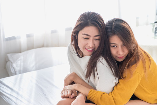 Asia lesbian lgbt couple hug and sitting on bed near white window sunlight with happiness moment together,love wins concept.
