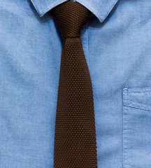 Men's stylish denim shirt and brown knitted tie