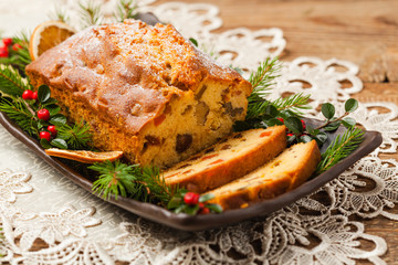 Christmas fruitcake. Natural wooden background.