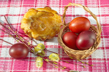 Easter still life with cake, painted eggs and willow twigs