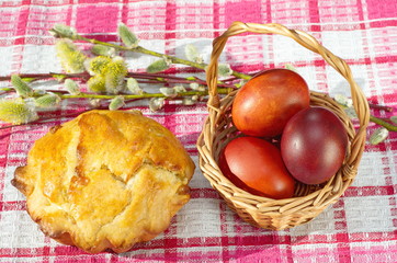 Easter composition with traditional Russian Easter cake - kulich, Easter eggs and willow branches on the table