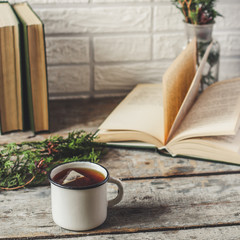 a cup of fresh and hot tea, and reading books