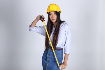 Beautiful Asian Architect Engineer woman in yellow hard hat
