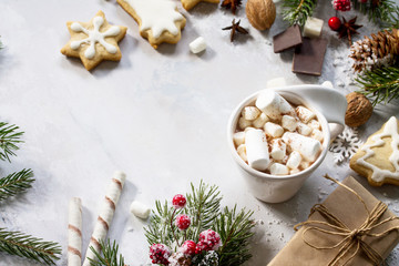 Christmas frame. A cup of hot chocolate and gingerbread, Christmas gifts on the table.