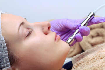 Diamond microdermabrasion, peeling cosmetic. woman during a microdermabrasion treatment in beauty salon