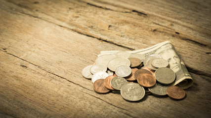 US dollar banknote and coins on natural wooden table, use as money saving concept , copyspace