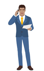 Businessman with paper talking on the mobile phone