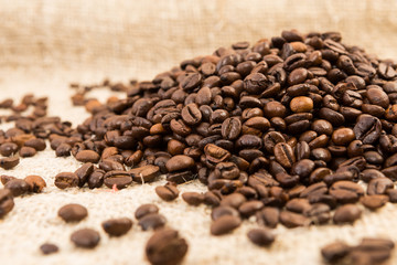 Fototapeta na wymiar Fresh roasted quality coffee beans on jute sack