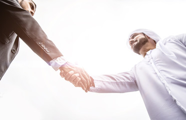 Arabic businessman giving an handshake to his business partner