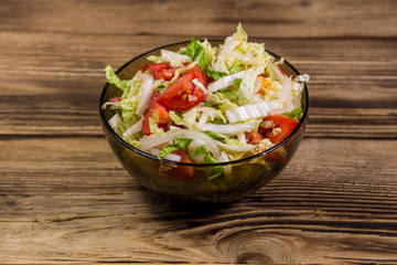 Fresh vegetable salad on wooden table