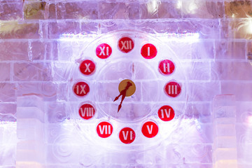 Ice clocks - original watch made of ice blocks with ligh bulbs. Outdoor decoration for Christmas and New Year celebration. Moscow, Russia.