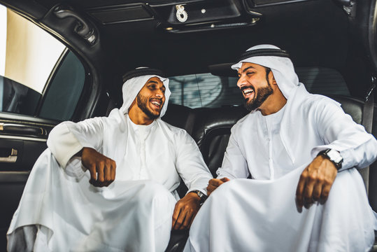 Two arabian businessmen talking about business in the company limousine