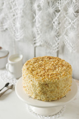 Napoleon cake made of puff pastry and custard vanilla cream on a white background. Rustic style.