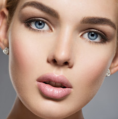 Face of a pretty gorgeous girl with blue sexy eyes
