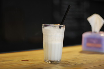 a glass of milk with straw