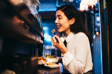 Japanese woman eating in a restaurant