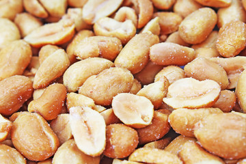 Peeled peanuts background food photography in studio. Close up macro peanuts photo. Beautiful salted roasted peanuts pattern concept. Photo