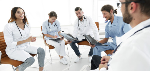 doctors discuss an x-ray ,sitting in the office.