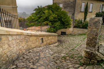 Fototapeta na wymiar ancient street made of stone named Rue de la Port Saint-Martin, in Saint-Emilion, France