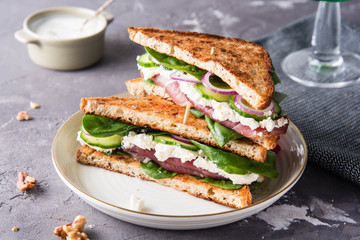 Sandwiches with cream cheese, ham and spinach.