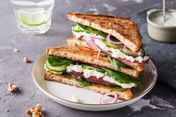 Sandwiches with cream cheese, ham and spinach.