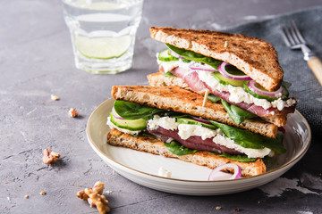 Sandwiches with cream cheese, ham and spinach.