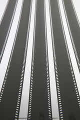 Fototapeta premium The unrolled exposed 35mm film strips over a white background