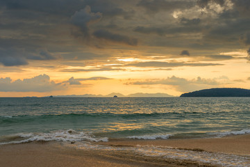 orange sunset in Thailand in golden tones, beautiful clouds over the sea