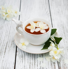 Cup of tea with jasmine flowers