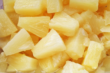 Pineapple slices as background. Yellow pineapples texture pattern. Photo.