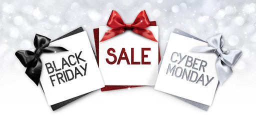 black friday and cyberg monday sale text write on gift card label with black, red and silver ribbon...