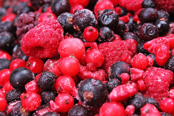 Frozen mixed berries berry as background. Blueberries,raspberries black berries and currant mulberry texture pattern