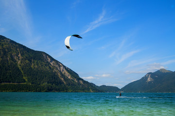 Kitesurfing on Walchensee with beautiful view towards the Bavarian Alps in Germany