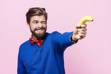 Man holding banana as a gun