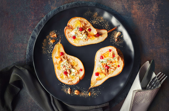 Pears baked with Blue cheese and walnuts, served with orange and cowberry jam on dark