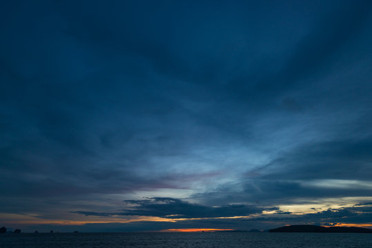 Dark sky with rain clouds over the sea after sunset