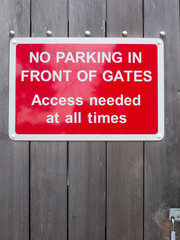 Naklejka premium no parking in front of gates access needed at all times red parking sign