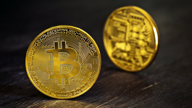 Golden Bitcoins on a wooden table .Photo (new virtual money ) 