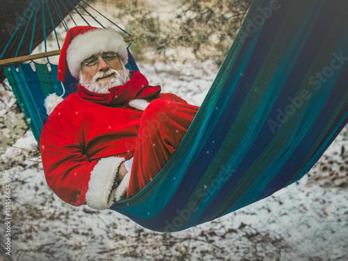 “Santa Claus relaxed in the hammock in the winter forest” Stock photo