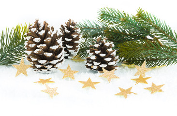 Golden glittering stars in the snow, with fir cones and fir branch