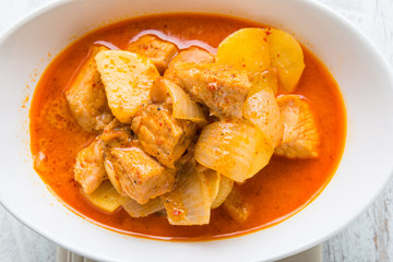 Massaman pork curry on wood background. Coconut milk curry.