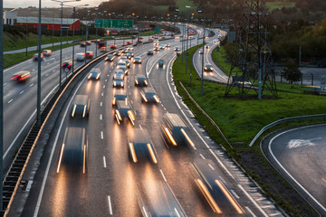 Fototapeta premium Morning rush hour traffic speeding by at dawn