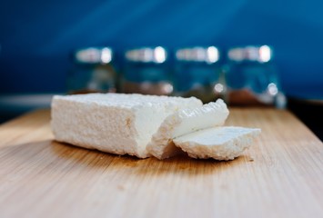 White healthy cottage cheese on wooden cutting board