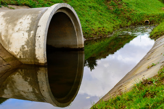 Concrete culvert pipe hole system draining sewage water. Environmental disaster
